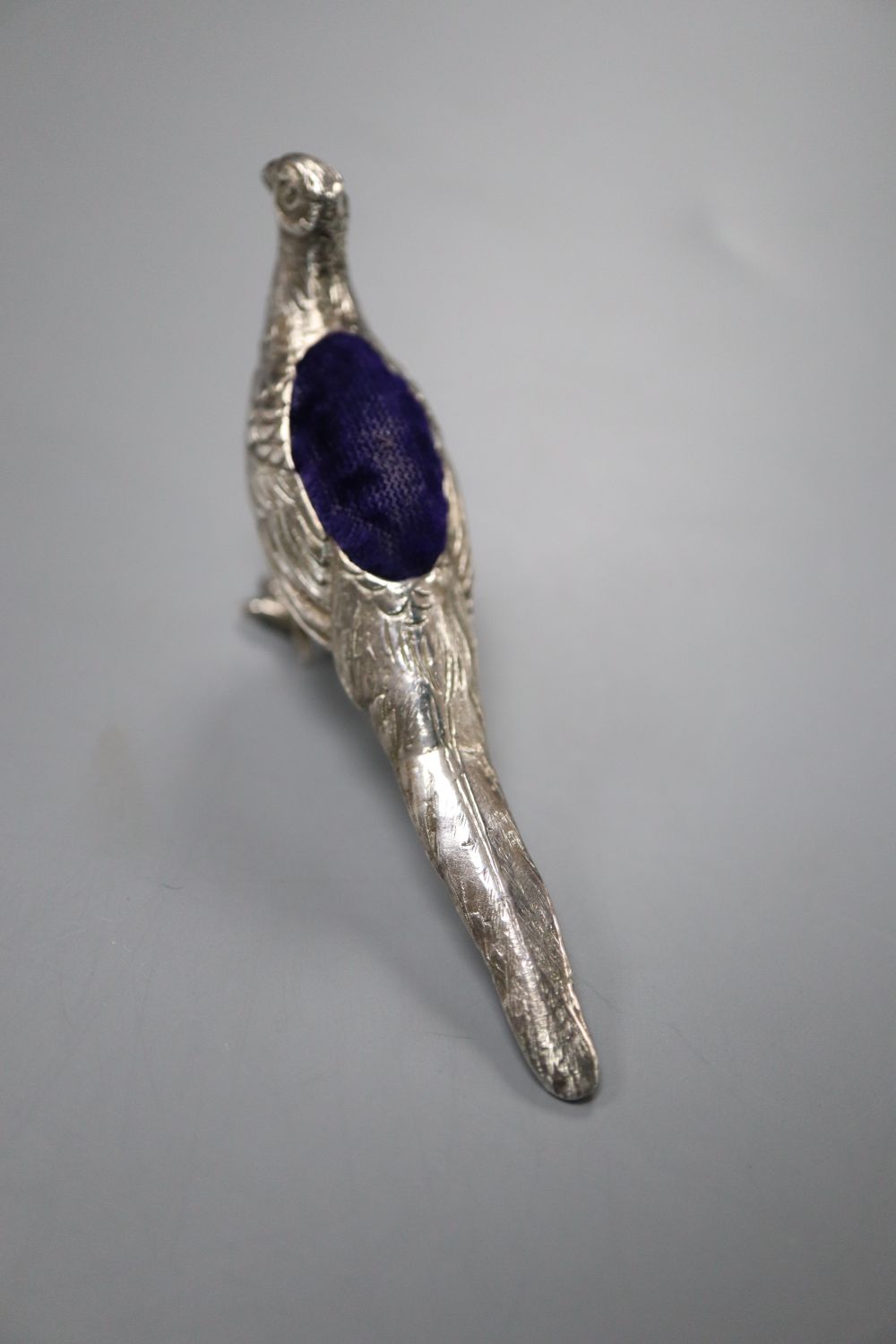An Edwardian novelty silver pin cushion, modelled as a pheasant, import marks for Glasgow, 1907, 84mm.